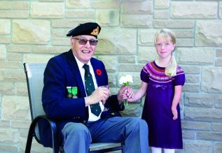 Photo: Charlie Jefferson, a Second World War amputee veteran and Isla McCallum, a member of The War Amps Child Amputee (CHAMP) Program.